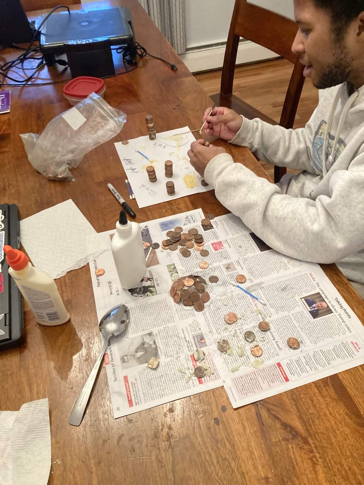 Jordan glueing pennies.