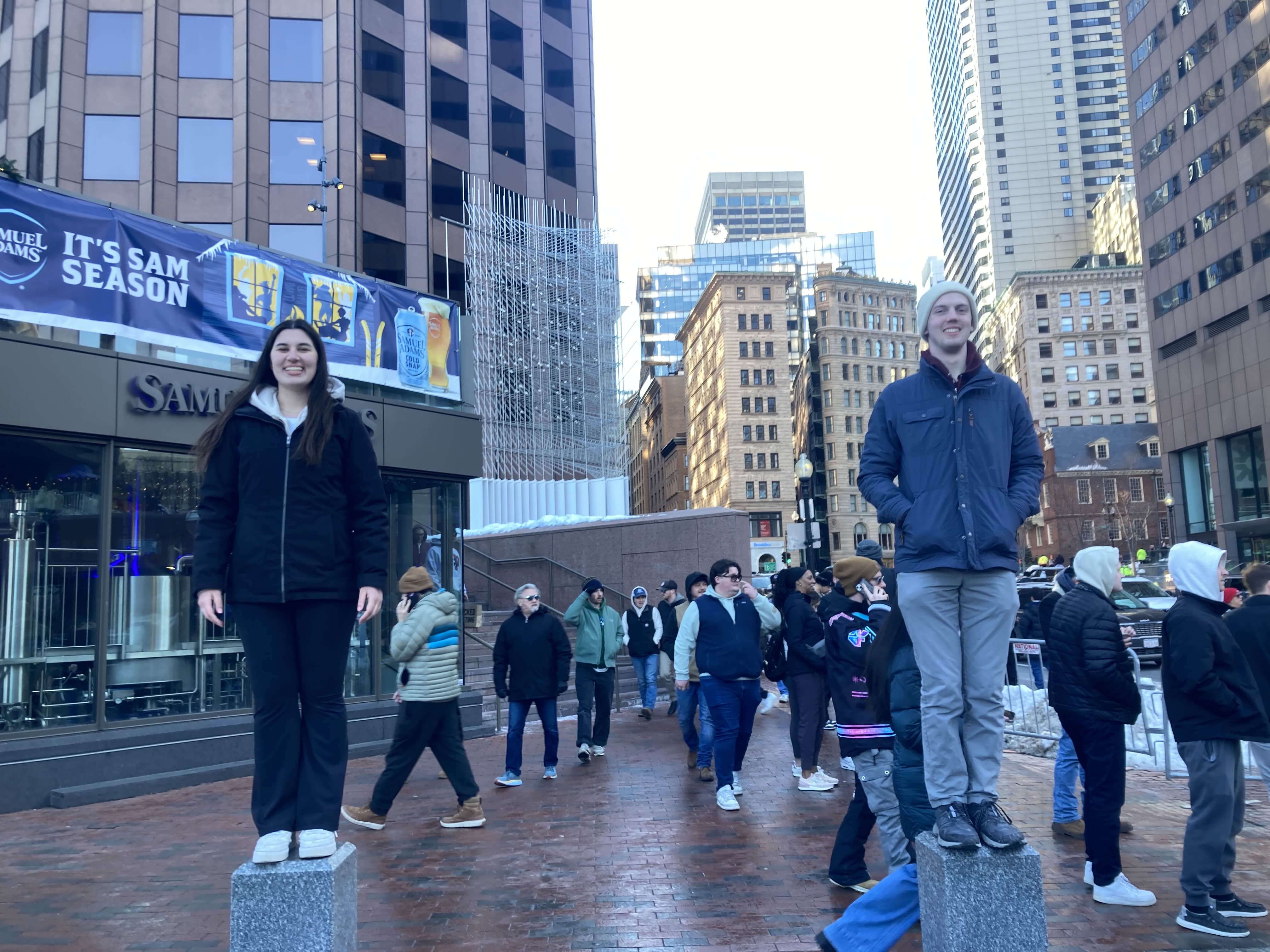 Maura and Ed standing on poles
